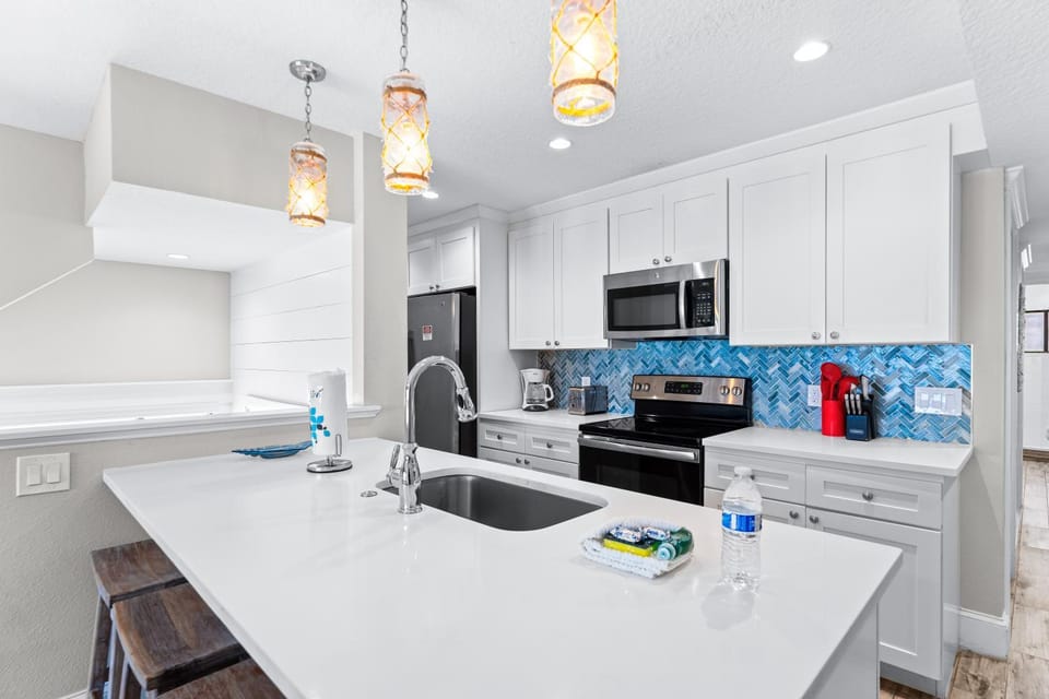 Kitchen or kitchenette, dishwasher, oven, stove