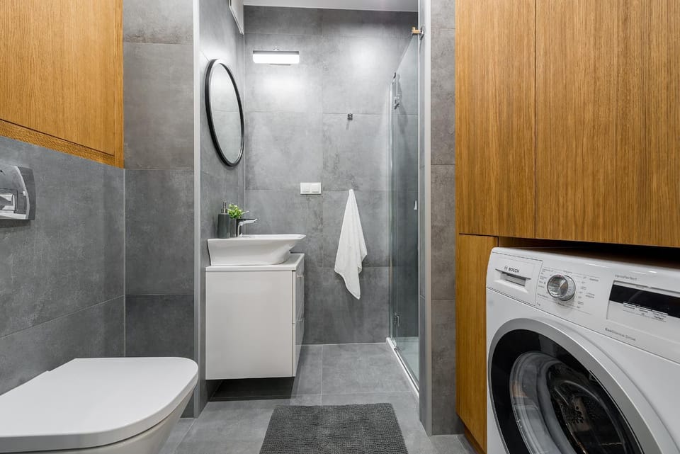 Shower, Toilet, Bathroom, hair dryier, towels, washing machine