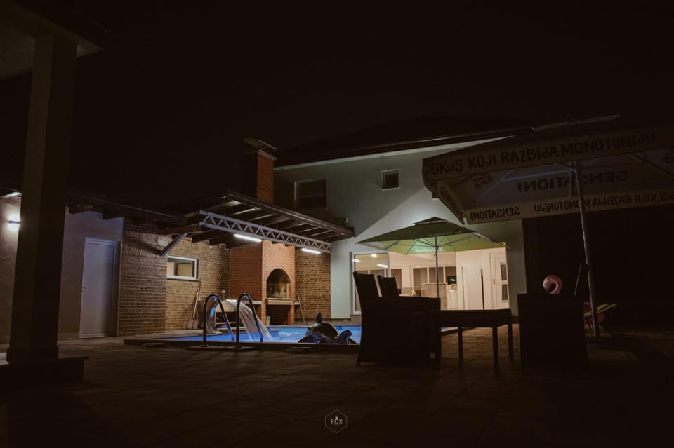 Property building, Patio, Night, Pool view, Swimming pool