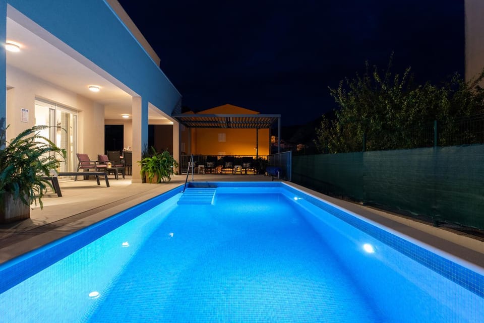 Property building, Patio, Night, Pool view, Swimming pool, sunbed