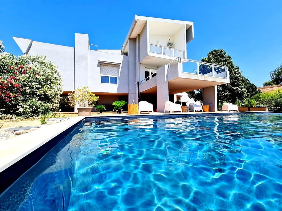 Property building, Patio, Pool view, Swimming pool, sunbed