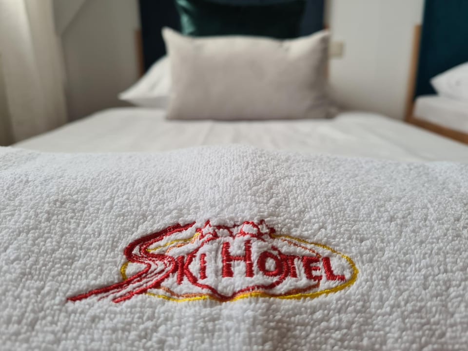 Bed, Property logo or sign, towels
