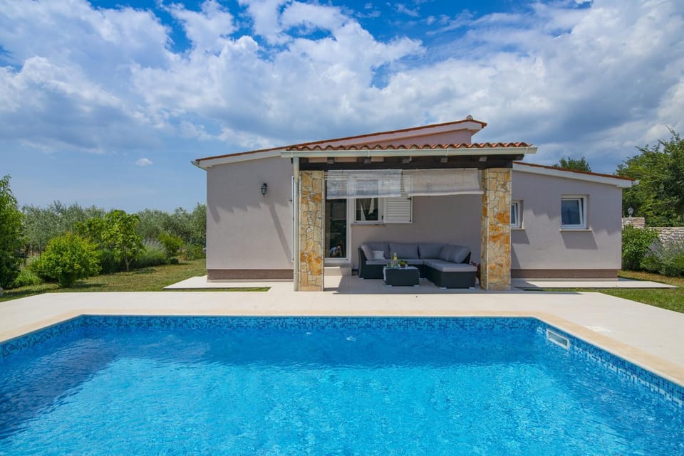 Property building, Patio, Facade/entrance, Day, Seating area, Pool view, Swimming pool, sunbed