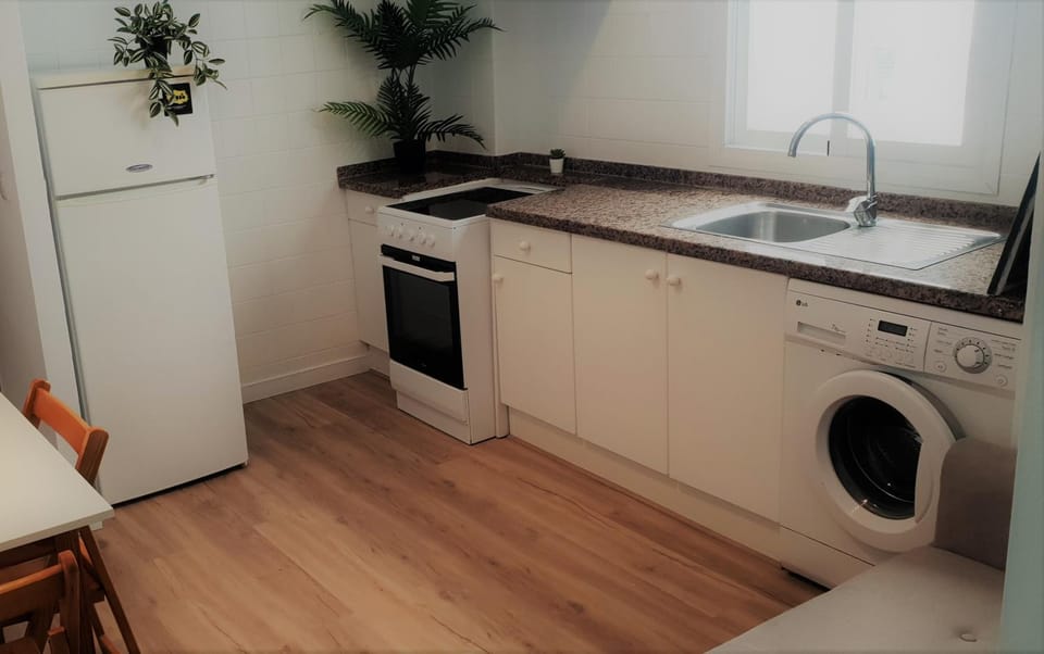 Kitchen or kitchenette, oven, stove, washing machine