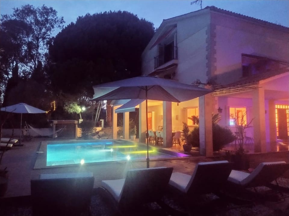 Property building, Patio, Night, Pool view, Swimming pool, sunbed