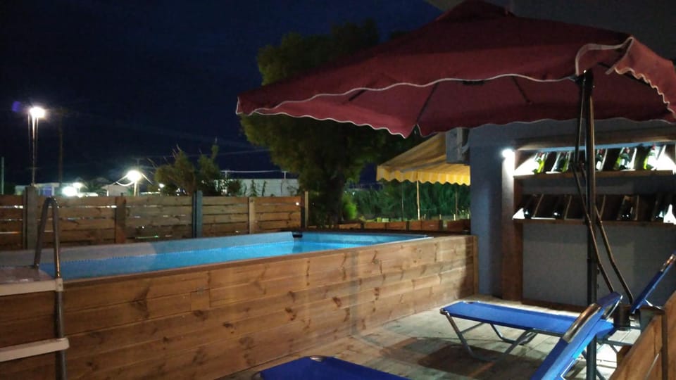 Property building, Patio, Night, Pool view, Swimming pool, sunbed