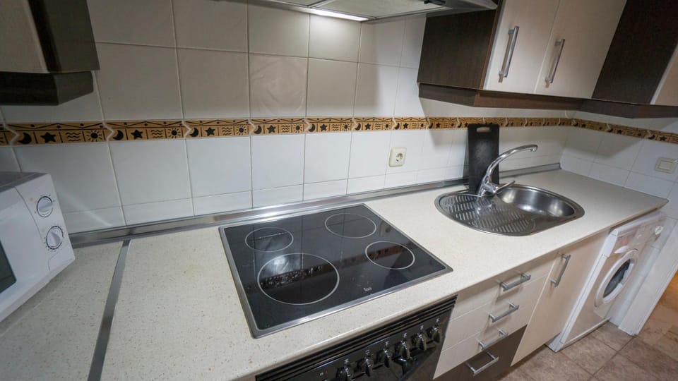 Kitchen or kitchenette, microwave, oven, stove, washing machine