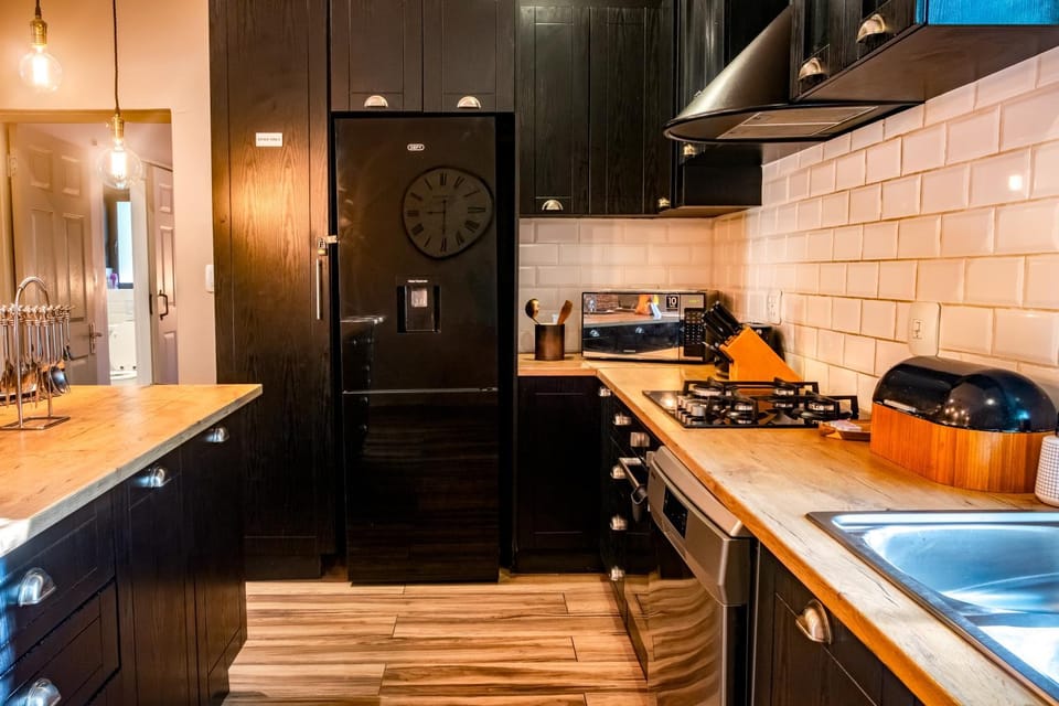 Kitchen or kitchenette, dishwasher, microwave, stove, toaster, toaster, washing machine, kitchen