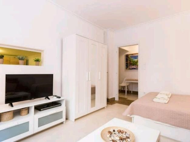 Bed, TV and multimedia, Living room, Seating area, wardrobe