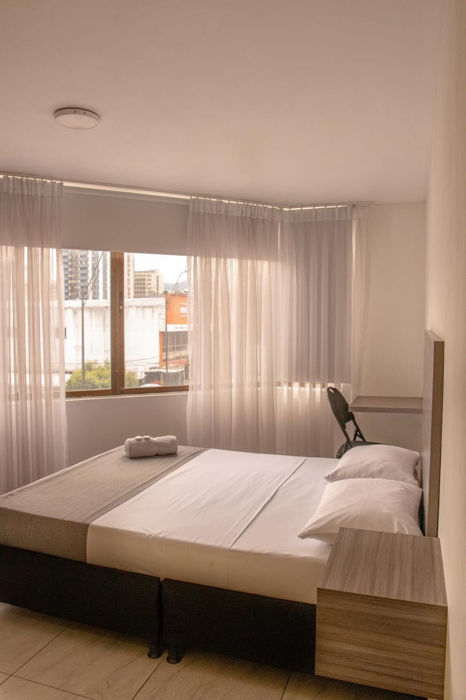 Bed, Photo of the whole room, Bedroom, City view, hair dresser, towels