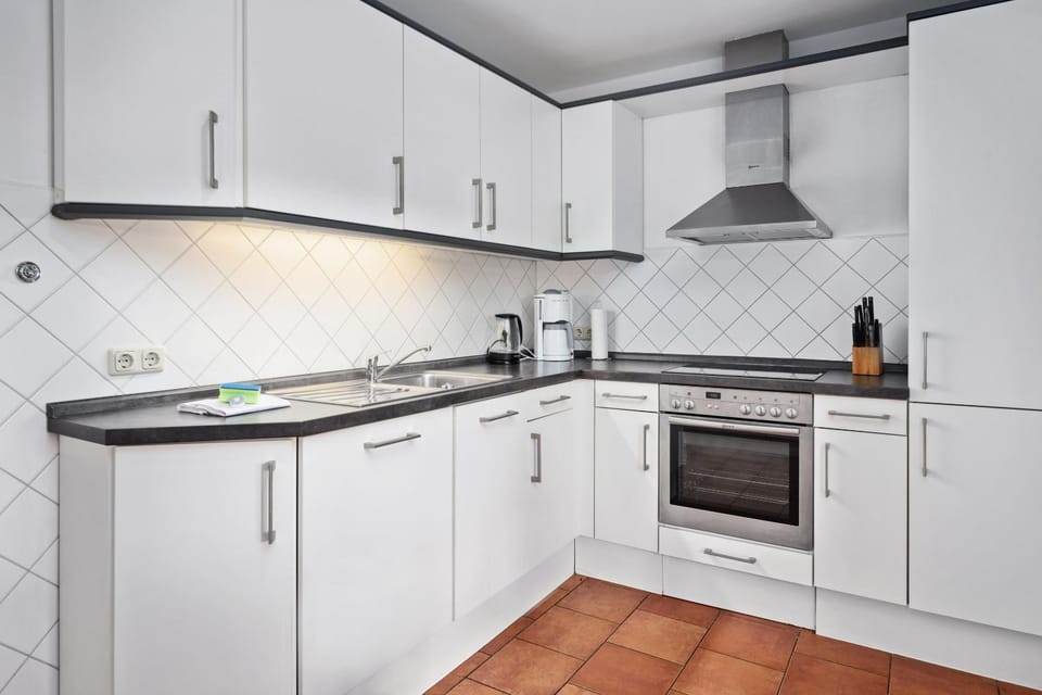 Kitchen or kitchenette, dishwasher, oven, stove