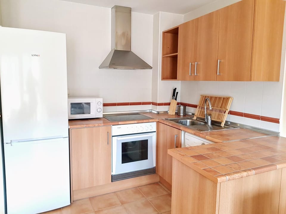 Kitchen or kitchenette, microwave, oven, stove, toaster, washing machine