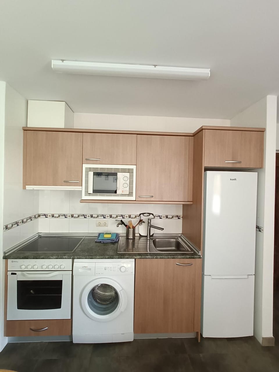 Kitchen or kitchenette, oven, stove, washing machine
