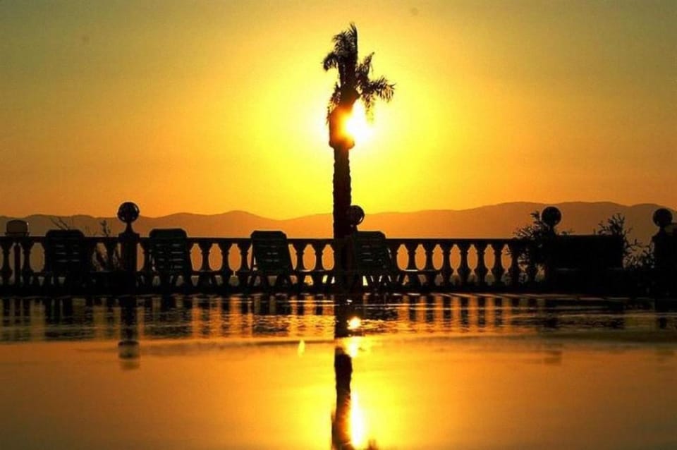 Property building, Off site, Natural landscape, Beach, On site, Text overlay, Pool view, Sea view, Swimming pool, Swimming pool, Sunrise, Sunset