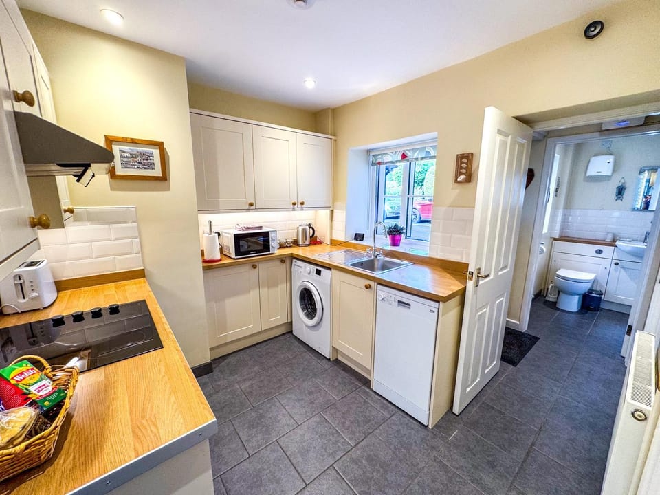 Kitchen or kitchenette, dishwasher, microwave, stove, washing machine