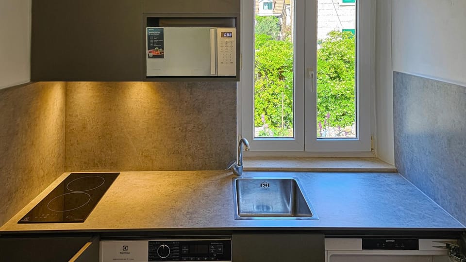 Kitchen or kitchenette, microwave, stove, washing machine, kitchen