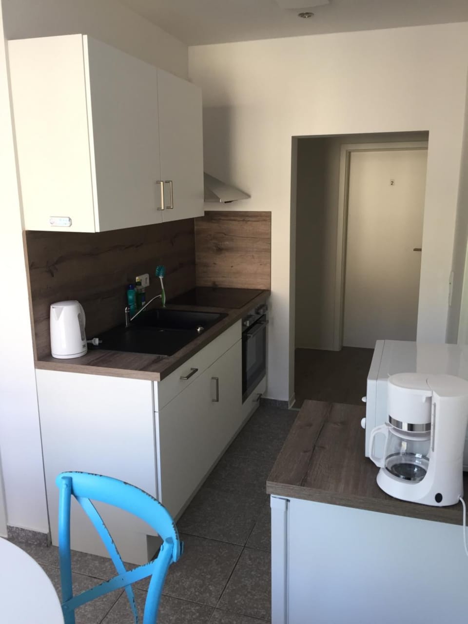 Kitchen or kitchenette, dishwasher, stove, toaster