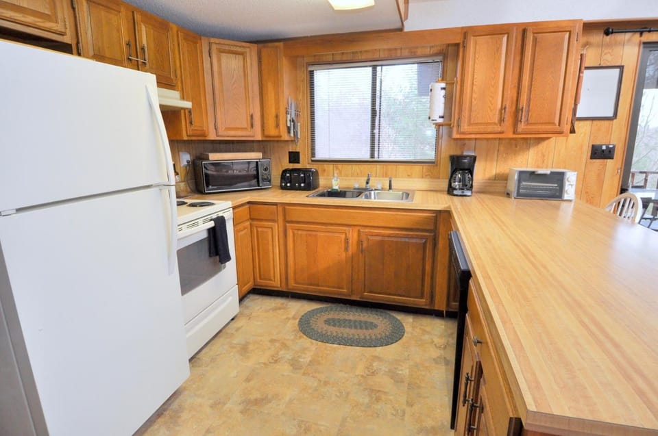 Kitchen or kitchenette, dishwasher, oven, stove, toaster