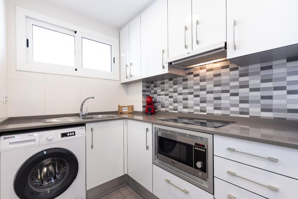 Kitchen or kitchenette, microwave, stove, washing machine, kitchen