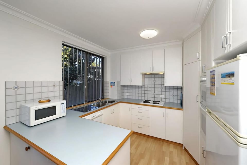 Kitchen or kitchenette, dishwasher, oven, stove