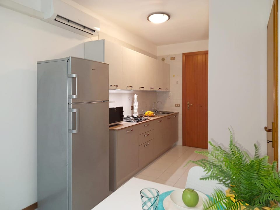 Kitchen or kitchenette, microwave, stove, air conditioner