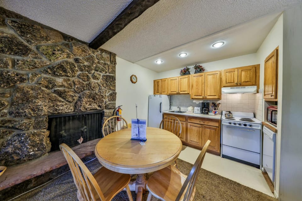 Kitchen or kitchenette, Dining area, fireplace, furniture, oven, stove