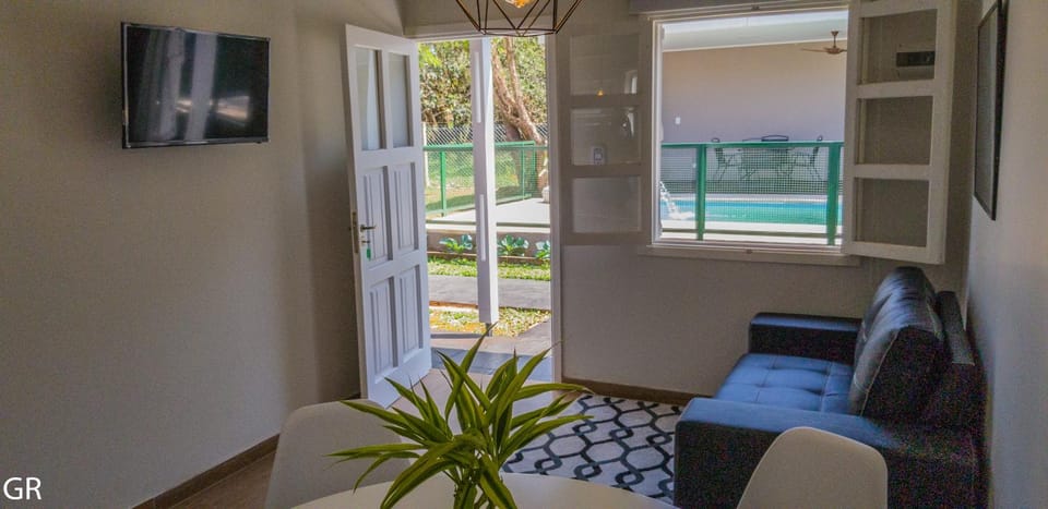 Living room, Seating area, Garden view, Pool view