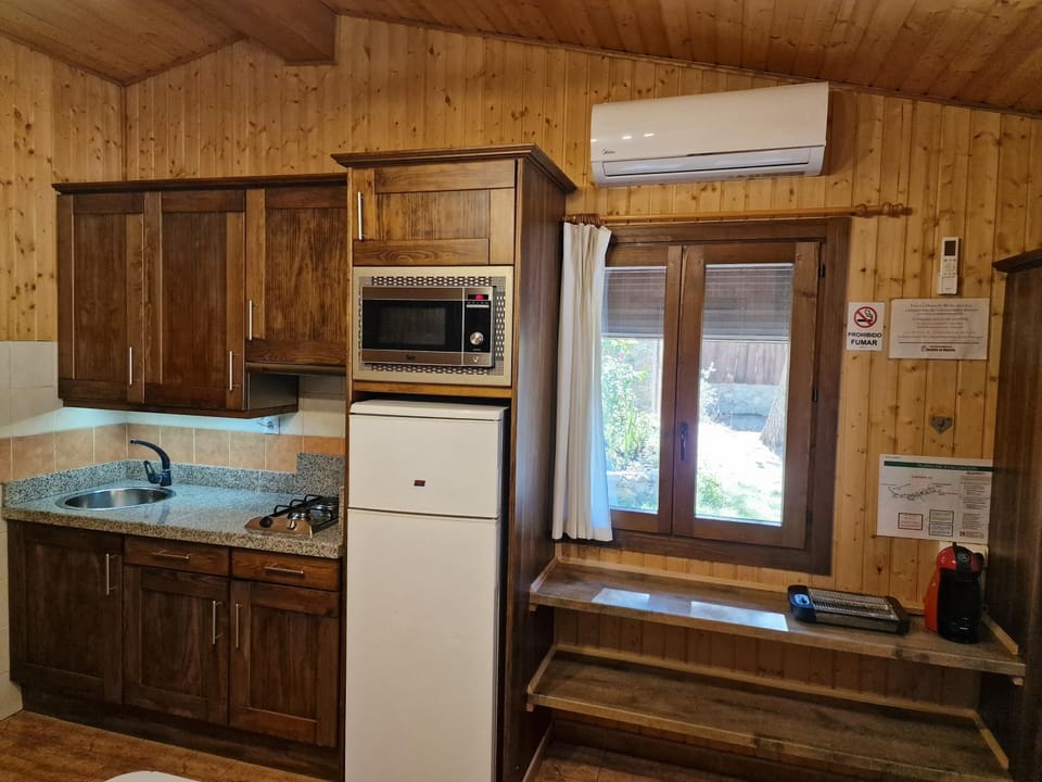 Kitchen or kitchenette, stove, air conditioner