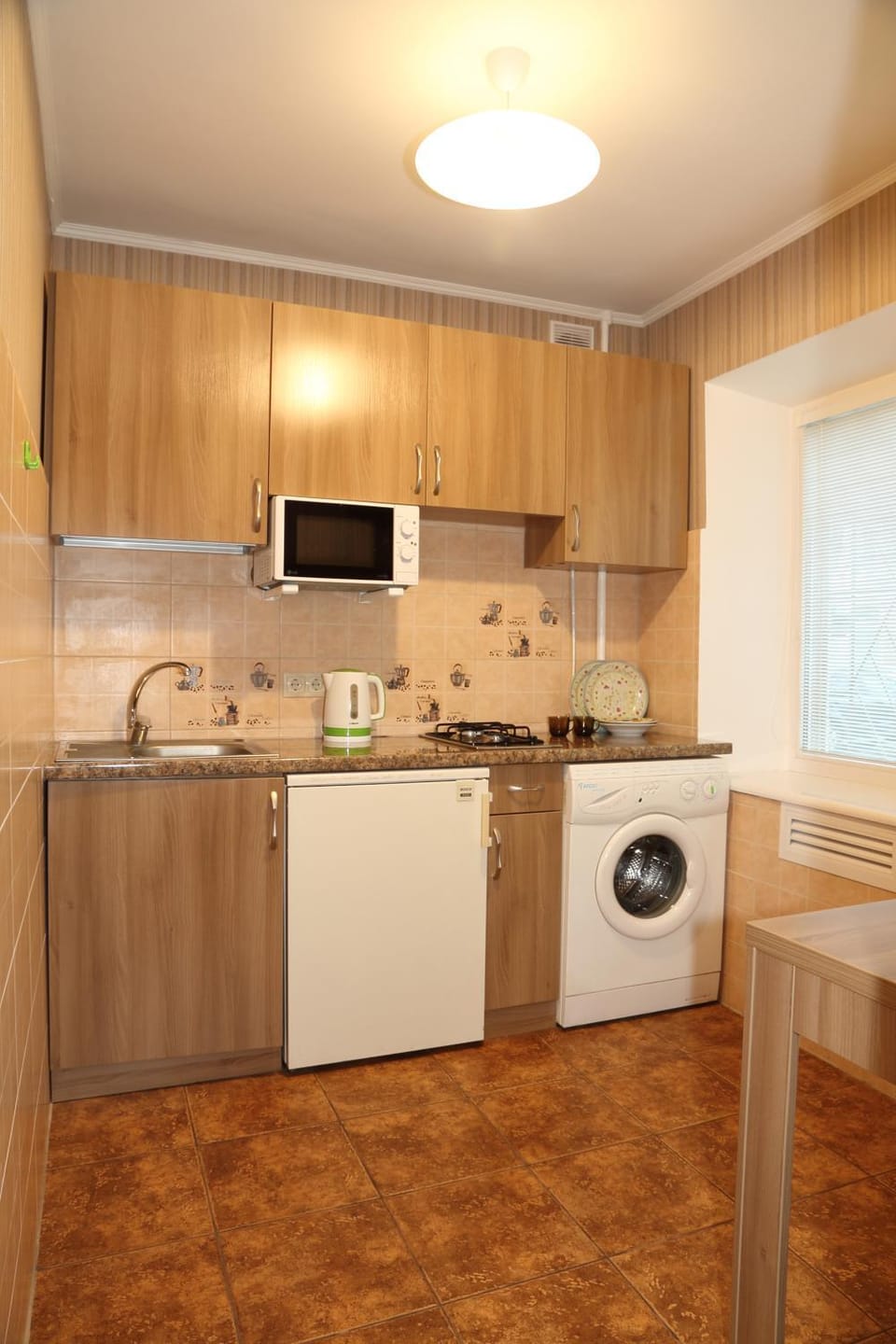 Kitchen or kitchenette, stove, washing machine
