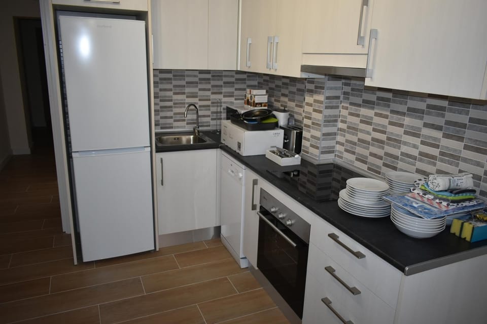 Kitchen or kitchenette, dishwasher, oven, stove, toaster