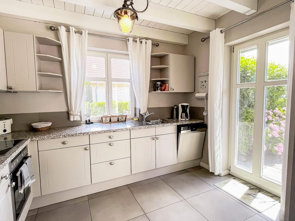 Kitchen or kitchenette, dishwasher, oven, stove