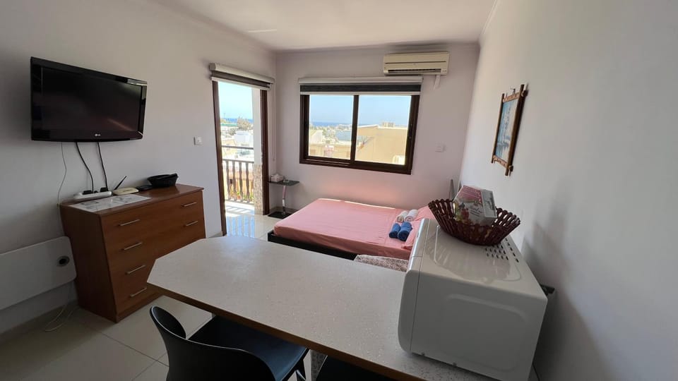 Bed, TV and multimedia, Living room, Seating area, Bedroom, hair dresser, air conditioner