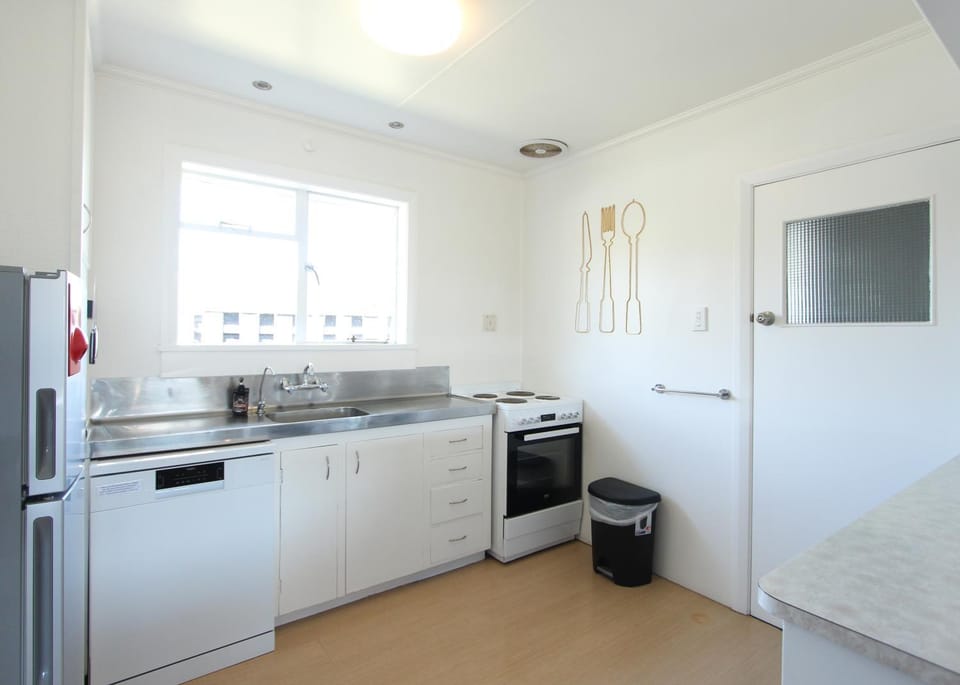 Kitchen or kitchenette, dishwasher, oven, stove