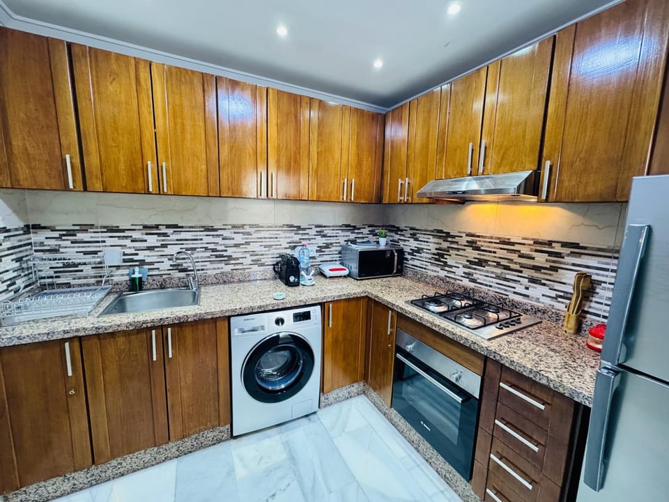 Kitchen or kitchenette, dishwasher, oven, stove, toaster, washing machine