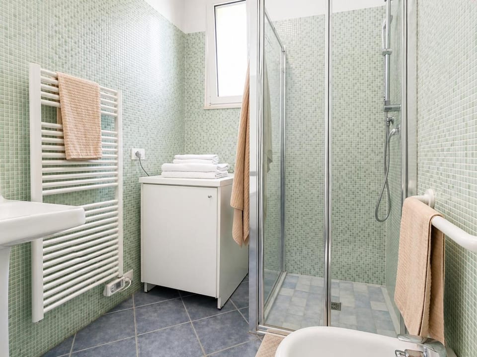 Shower, Toilet, Bathroom, hair dryier, towels, washing machine