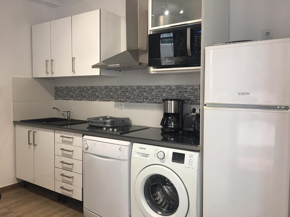 Kitchen or kitchenette, dishwasher, microwave, stove, washing machine
