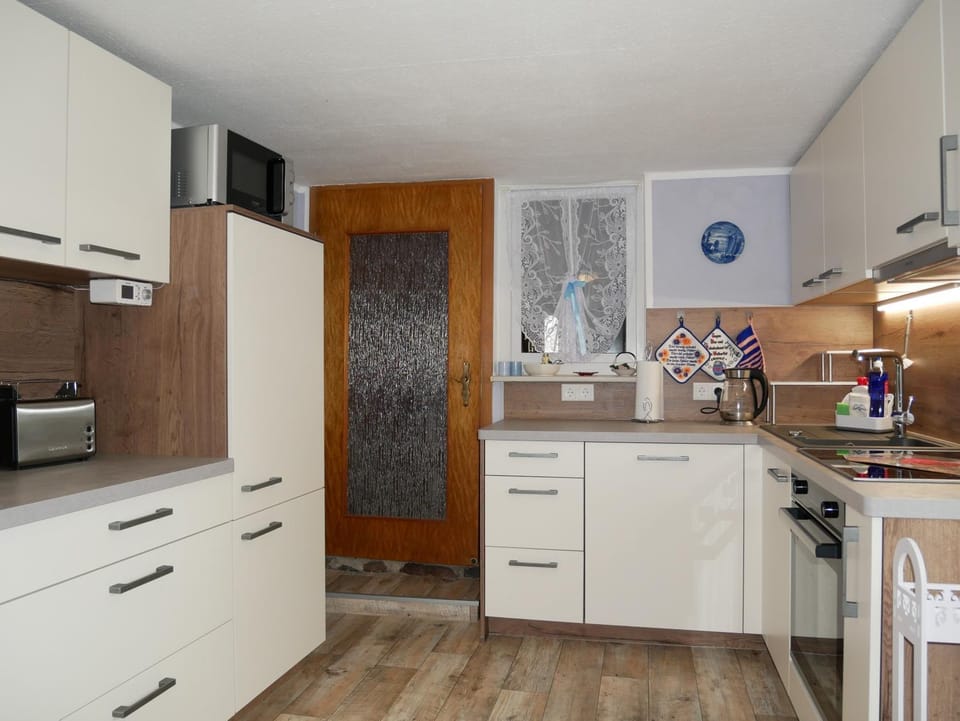 Kitchen or kitchenette, dishwasher, oven, stove