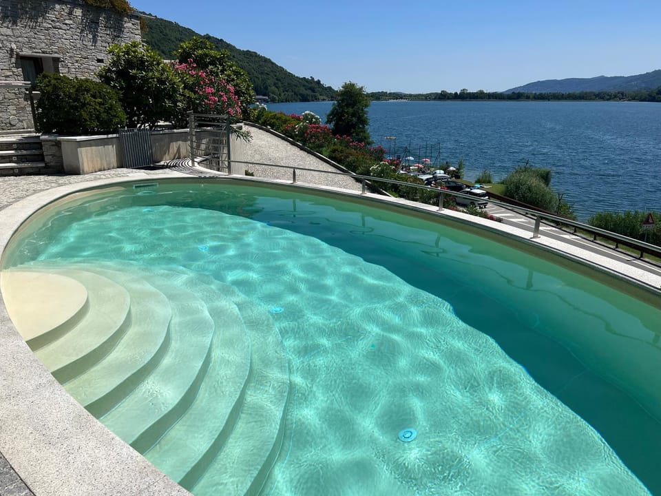 Property building, Nearby landmark, Day, Natural landscape, Lake view, Mountain view, Pool view, Swimming pool