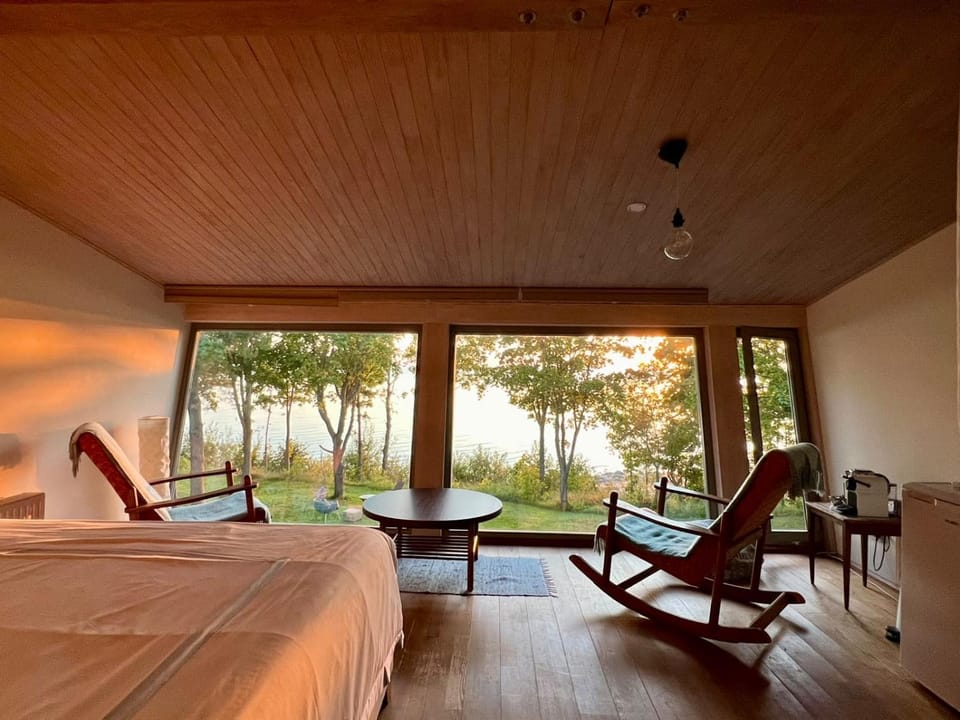 Bed, Natural landscape, View (from property/room), Seating area, Bedroom, Sea view, Sunset