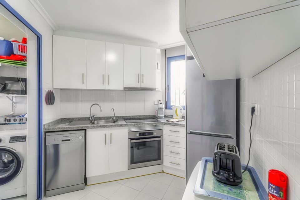 Kitchen or kitchenette, dishwasher, oven, stove, toaster, washing machine