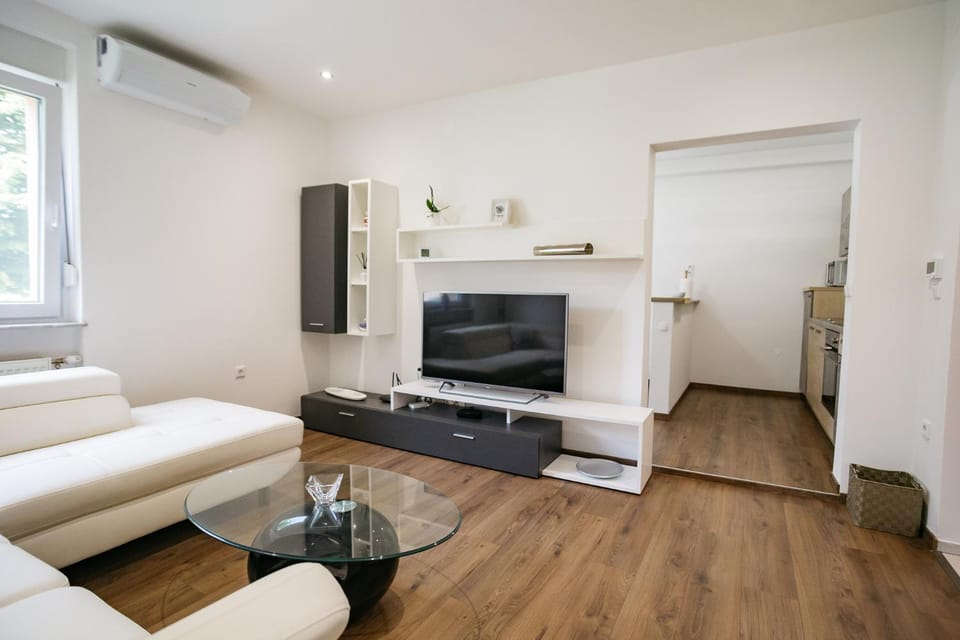 Property building, TV and multimedia, Living room, Seating area, air conditioner