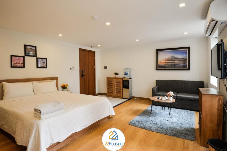 Bed, Property logo or sign, TV and multimedia, Living room, Photo of the whole room, Seating area, Bedroom, Text overlay, Certificate/Award, hair dresser, towels, air conditioner