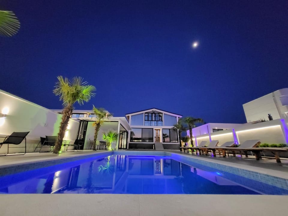 Property building, Night, Pool view, Swimming pool, Swimming pool, sunbed