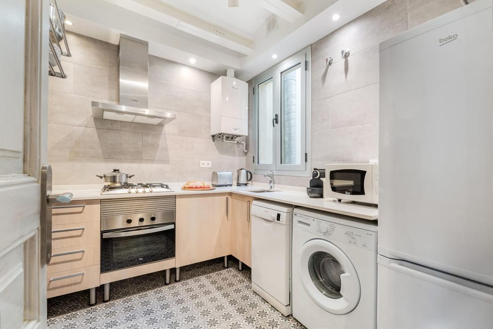 Kitchen or kitchenette, dishwasher, microwave, oven, stove, toaster, washing machine