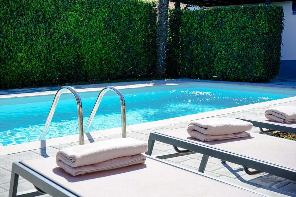 Swimming pool, sunbed, towels