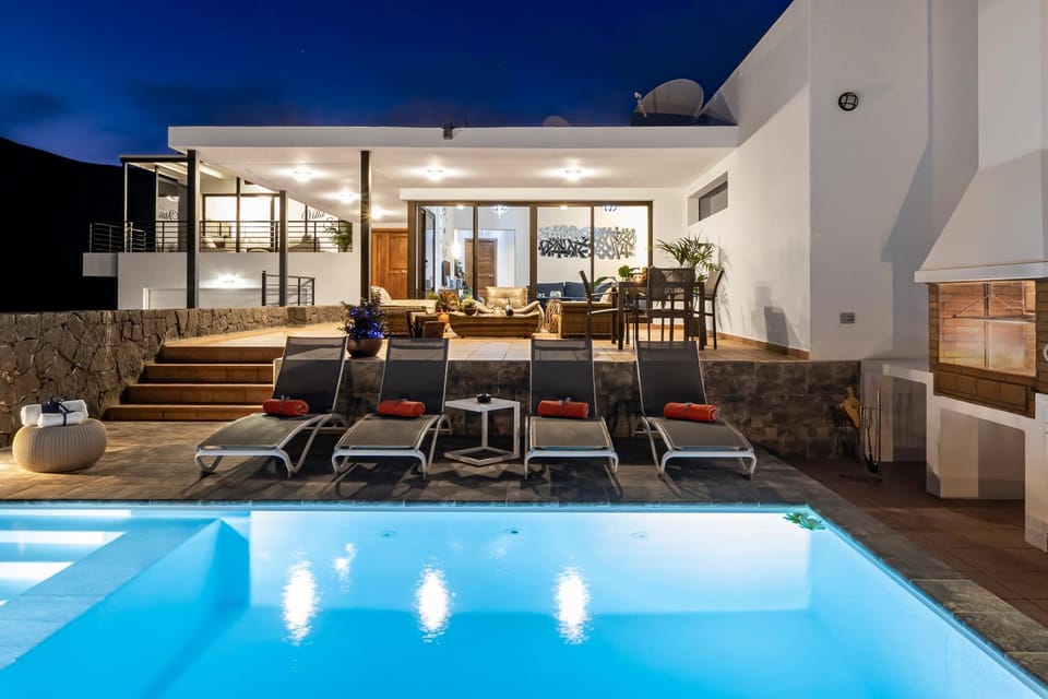 Property building, Patio, Night, Swimming pool, Swimming pool, sunbed
