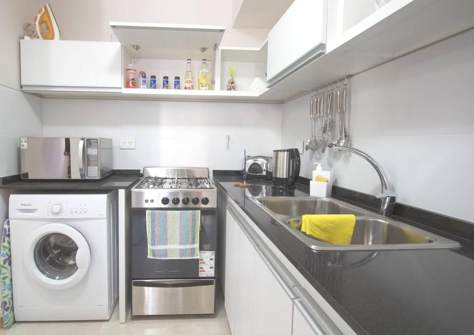 Kitchen or kitchenette, oven, toaster, washing machine