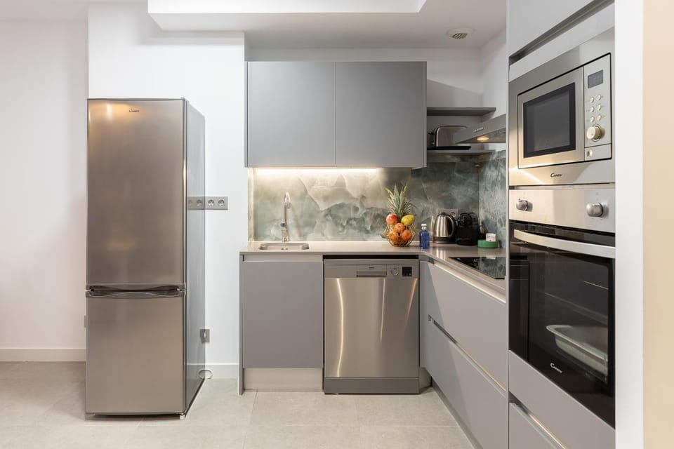 Kitchen or kitchenette, dishwasher, oven, stove