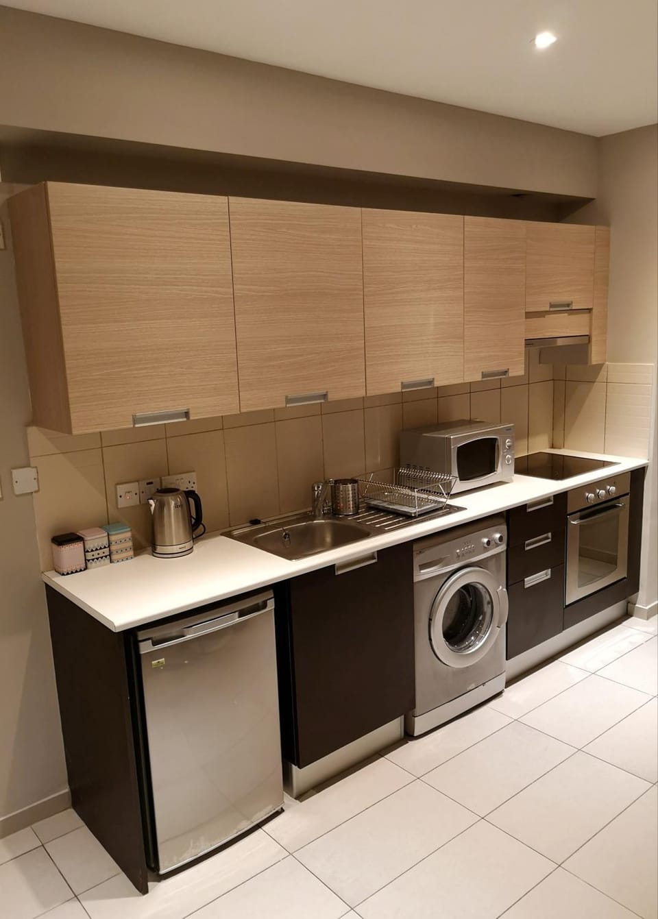 Kitchen or kitchenette, microwave, oven, stove, washing machine
