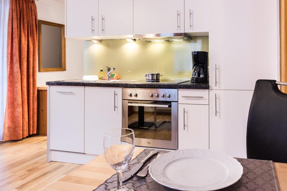 Kitchen or kitchenette, dishwasher, oven, stove